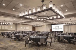 a banquet hall with tables and chairs and a projection screen at The Scottsdale Resort & Spa, Curio Collection by Hilton in Scottsdale +80 photos