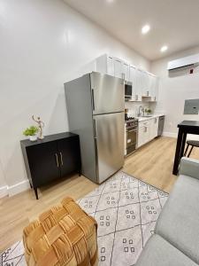 a kitchen with a stainless steel refrigerator and a table at 241- Convenient City Stay in Hoboken