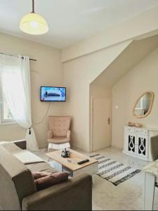 a living room with a couch and a table at Alegria apartments in Gaios