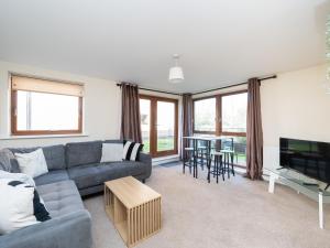 a living room with a couch and a table at Crawley 2 bed flat with Parking in Crawley