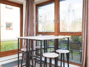 a table and stools in front of a window at Crawley 2 bed flat with Parking in Crawley