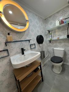 a bathroom with a sink and a toilet at Milele in Sigale +17 photos