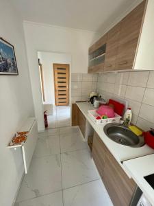 a small kitchen with a sink and a counter at MaNo Apartman Siófok in Siófok +26 photos