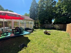 a patio with a table and chairs in a yard at MaNo Apartman Siófok in Siófok