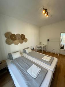a bedroom with a large bed with a ceiling at MaNo Apartman Siófok in Siófok