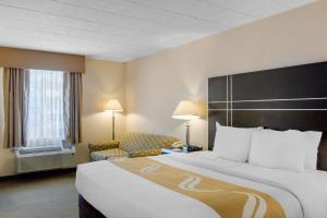 a hotel room with a large bed and a chair at Quality Inn Ledgewood - Dover in Ledgewood +38 photos