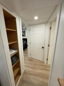 a hallway with a white door and a closet at Private Suite Jones Lake- West Moncton in Moncton