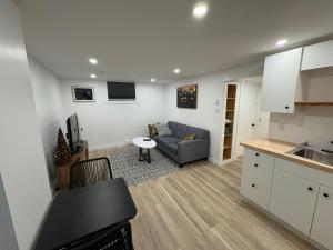 a kitchen and living room with a couch and a table at Private Suite Jones Lake- West Moncton in Moncton