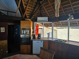 a kitchen with a black refrigerator and a counter top at FARE MOOREA in Moorea
