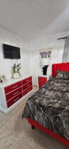 a bedroom with a bed and a flat screen tv at Carrasco Apartamentos in Nagua