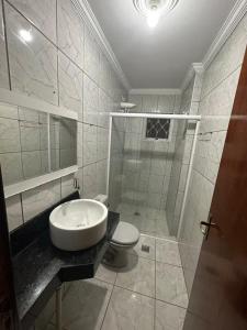 a bathroom with a sink and a shower with a toilet at Casa Canto do Rio in Socorro +42 photos