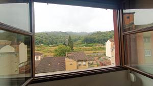 a view of a city from a window at Atico moderno en Langreo in Langreo