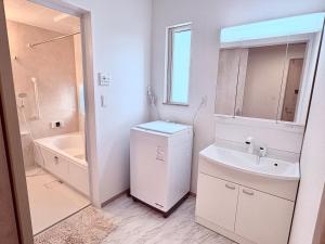a bathroom with a sink and a washer and dryer at SAKURA HOTEL - Vacation STAY 35483v in Hanawadamachi +36 photos