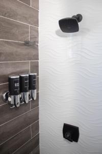 a bathroom with a white door with cups on the wall at Carrasco Apartamentos in Nagua +43 photos