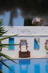 a model of a house next to a swimming pool at Alacati Naz Konak in Çeşme