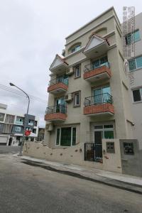 a building with balconies on the side of a street at Bear Homestay in Taitung City