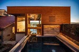 a house with a swimming pool in front of it at Casa Perfeuto Maria in Cabana Moura 