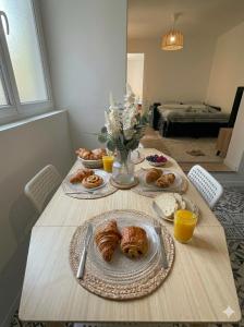a table with plates of pastries on top of it at Le Loft d'Azur - Cozy - Netflix in Fontainebleau