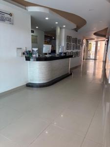 a lobby with a bar in the middle of a building at Hotel Chayrama in Santa Marta +76 photos