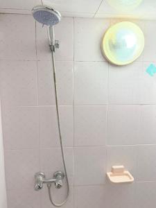 a shower with a shower head in a bathroom at Airport agadir villa in Agadir +18 photos