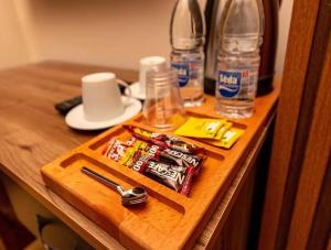 a wooden table with a cutting board with drinking glasses at İstanbul Royal Hotel Kumkapı in Istanbul