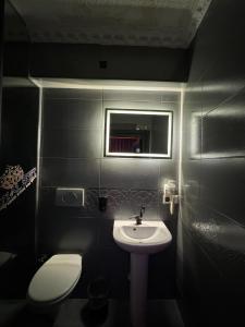 a bathroom with a sink and a toilet and a mirror at İstanbul Royal Hotel Kumkapı in Istanbul +61 photos