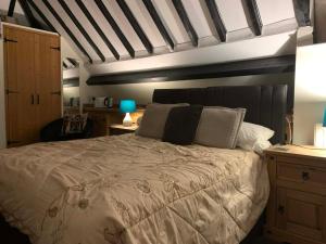 a bedroom with a large bed with a white comforter at Broadwalk 6 in Coltishall