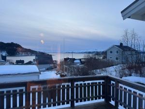 a view from a balcony with snow on the ground at Northbound Sea View Retreat in Sortland