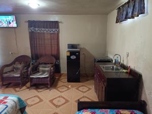 a small kitchen with a sink and a refrigerator at Sweet Dreams in Bluefields +10 photos