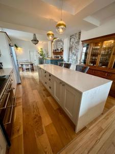 a large kitchen with a large white counter top at Wigtown House in Wigtown