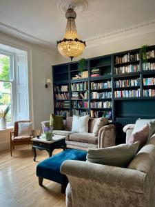 a living room with two couches and bookshelves at Wigtown House in Wigtown