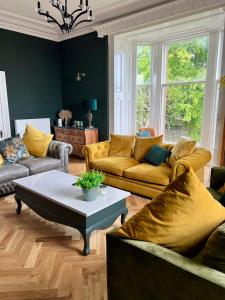 a living room with couches and a coffee table at Wigtown House in Wigtown