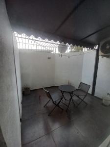a table and chairs in a room with a window at Monoambiente Evanz in Ciudad Lujan de Cuyo