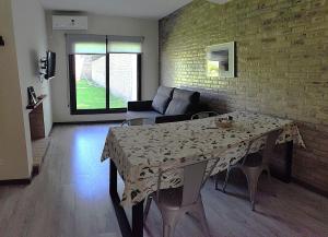a living room with a table and a couch at Terroir Village - Complejo en Mendoza in Guaymallen