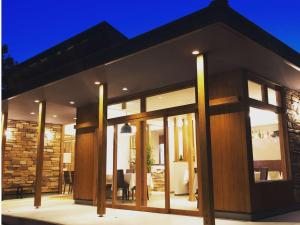 a modern house with glass doors and a dining room at scene - Vacation STAY 52631v in Daisen