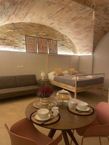 a living room with a table and a bed at A Casa di Costanza in Atri +13 photos
