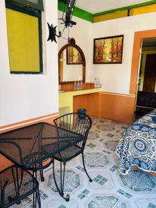 a room with a table and chairs and a counter at Hotel Plaza Macondo in Comonfort