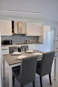 a kitchen with a table with chairs and a dining room at Bluelow Lakeview house in Dervio