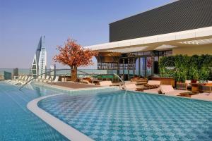 a swimming pool on the roof of a building at Conrad Bahrain Financial Harbour in Manama