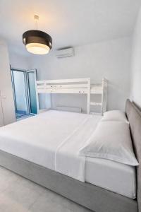 a bedroom with a white bed and a light at Bluelow Lakeview house in Dervio +18 photos