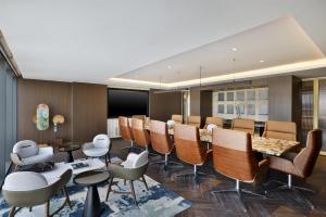 a waiting room with chairs and tables in a room at Conrad Bahrain Financial Harbour in Manama +176 photos