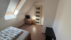 a small bedroom with a bed and a window at Ubytování Divišov in Divišov
