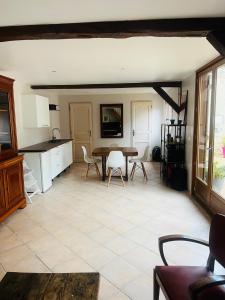 a kitchen and dining room with a table and chairs at La maisonnette in Warmeriville