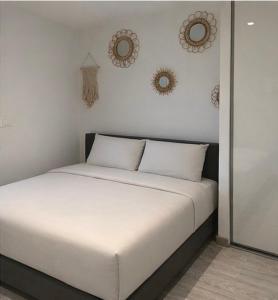a bed in a room with three mirrors on the wall at Maison avec piscine in Golbey +25 photos