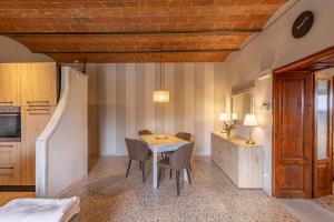 a kitchen with a table and chairs in a room at Dimora San Lazzaro Tuscany in Cetona