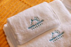 a pair of towels sitting on top of a table at Dimora San Lazzaro Tuscany in Cetona +4 photos
