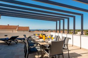 a table and chairs on a balcony with a view at Villa Ursula in Pakoštane