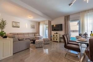 a living room with a couch and a table at Villa Ursula in Pakoštane