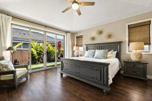 a bedroom with a bed and a ceiling fan at Holua Kai 37 in Kailua-Kona