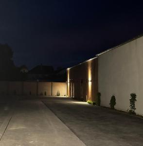 a large building with lights on the side at night at Studio PRINTEMPS in Sens